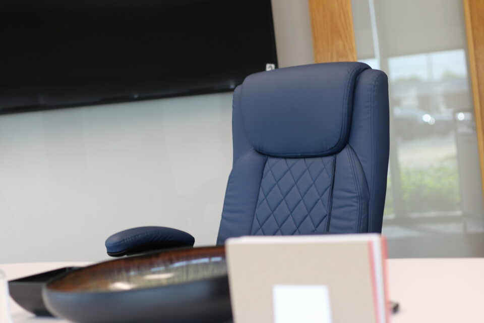 Conference room with a large-screen monitor for hybrid sessions